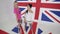 Funny girls dancers stare at camera and move in white studio with big UK flag