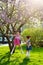 Funny girls walking on the lawn with her mother. Sisters play together with mom. maternal care. happy family