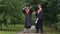 Funny graduates in academic gowns dancing and fooling around after graduation