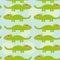 Funny green iguana Seamless pattern with cute animal on a blue b
