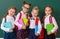 Funny group children   schoolboy  and schoolgirl, student boy  and girl about school blackboard