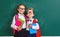 Funny group children   schoolboy  and schoolgirl, student boy  and girl about school blackboard