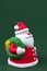 Funny gypsum colorful santa claus isolated over green background. New Year and Christmas concept.