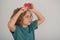 Funny hairstyle. Kids hair care concept. Portrait of kid brushing her unruly, tangled long hair on  studio