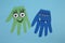 Funny hand shaped monsters on light blue background, flat lay. Halloween decoration