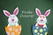 Funny handmade cartoon rabbits placed inside eggs with text in G