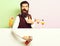 Funny handsome bearded barman on purple green studio background