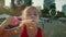 Funny happy little girl smiling child adorable looking at camera is play on Beach. Baby play with soap bubbles. Kid