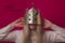 Funny happy woman in gold cardboard crown on the pink background