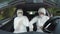 Funny hazmat scientist workers in car dancing and putting on gloves and suit preparing for investigation -