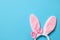 Funny headband with Easter bunny ears on color background, top view