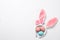 Funny headband with Easter bunny ears and dyed eggs white background