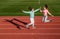 funny healthy children girls training fitness on stadium running track, sport success