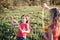 Funny hilarious moment. Girls friends blowing soap bubbles in park on summer day. Kids having fun outdoors. Authentic happy