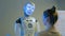 Funny humanoid robot with display face talking with woman