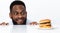 Funny Hungry Black Man Looking At Burger Over White Background