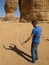 A funny image of a man arguing with his own shadow in front of the Elephant Rock in Saudi Arabia KSA