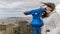 Funny image of a smiling woman with her hair disheveled by the wind observing through a telescope