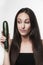 Funny image of young woman holding zucchini