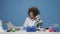 Funny insane female scientist looking at test tubes on desk