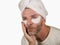 Funny isolated face portrait of young happy and attractive camp gay man  applying moisturizer eye patch facial product with head