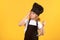 Funny kid chef cook with kitchen ladle, studio portrait. Kid in cooker uniform and chef hat preparing food on studio