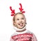 Funny kid with Christmas band. Cheerful smiling little girl .