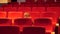 Funny kid in a empty cinema hall moving restless on a chair