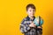 Funny kid with globe, isolated on yellow. Back to school concept. Educational globe. Curious child holding earth globe map in his