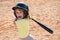 Funny kid up to bat at a baseball game. Close up child portrait.