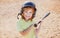 Funny kid up to bat at a baseball game. Close up child portrait.