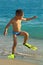 Funny kid walking the beach wearing flippers