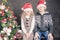 Funny kids at Christmas holiday near decorated christmas tree