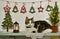 Funny kitty cat laying on shelf with conifer, lantern and decorations