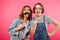 Funny ladies friends holding fake moustache and glasses.