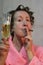 Funny lady with curlers, champagne and a cigar
