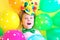 Funny laughing child clown with multicolored balloons. Birthday party concept. April fools& x27; day celebration concept.