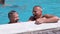 Funny Laughing Father with Son Swim in Open Transparent Swimming Pool.