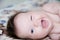 Funny laughing infant portrait, happy smiling baby winking