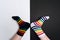 Funny legs with white and black striped new clean colorful textile socks. Fashion accessories for feet with negative background