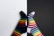 Funny legs with white and black striped new clean colorful textile socks. Fashion accessories for feet with negative background