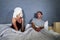 Funny lifestyle portrait of man and woman featuring weird married couple with wife in head towel and makeup face mask demanding se