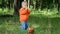 Funny little boy of 1,5 years studying mushrooms in a basket