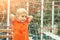 Funny little boy on playground with a grid of football gate