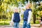 Funny little brother and sister of Caucasian ethnicity play on a public chess venue in a city park. Children frolic and indulge