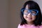 Funny little child with big blue glasses