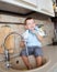 Funny little child boy washing dish on kitchen