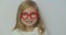 Funny little child girl wear red glasses holding stethoscope playing game as doctor, happy cute adorable small preschool