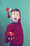 Funny little child with red dumbbell and apple