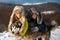 Funny little children embraced husky dog in winter outdoor. Smiling kids friends hug dog in frost snowy day outdoor. Two